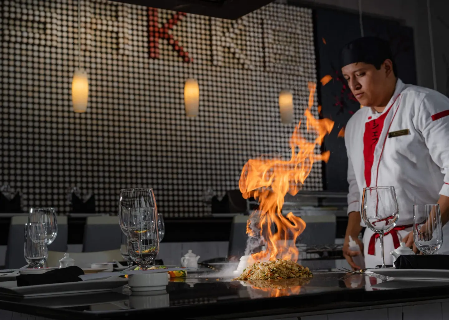 Teppanyaki chef cooking with flames at Marquis Los Cabos.