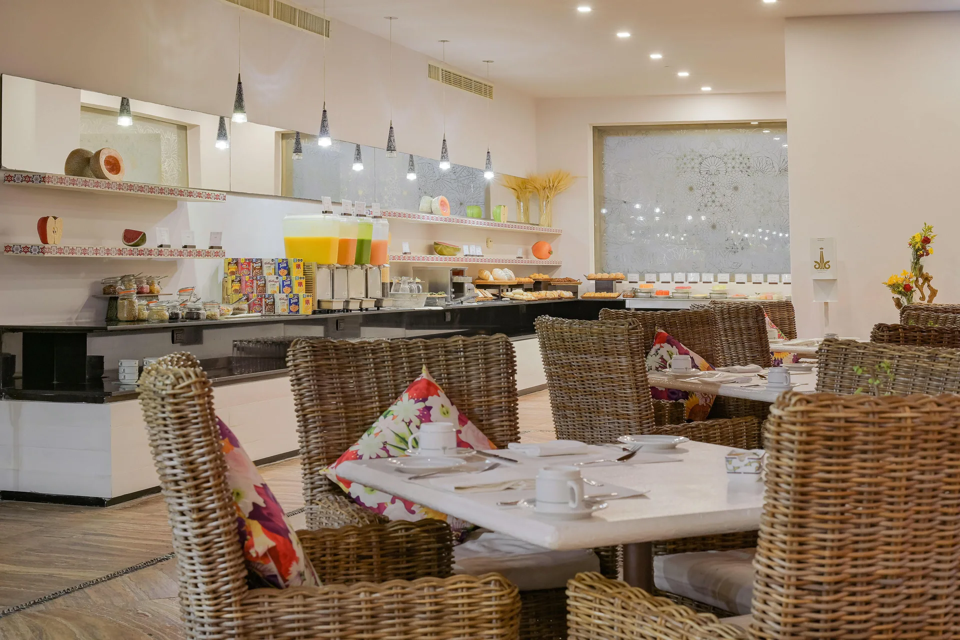 Breakfast buffet dining room with wicker chairs at Marquis Los Cabos.