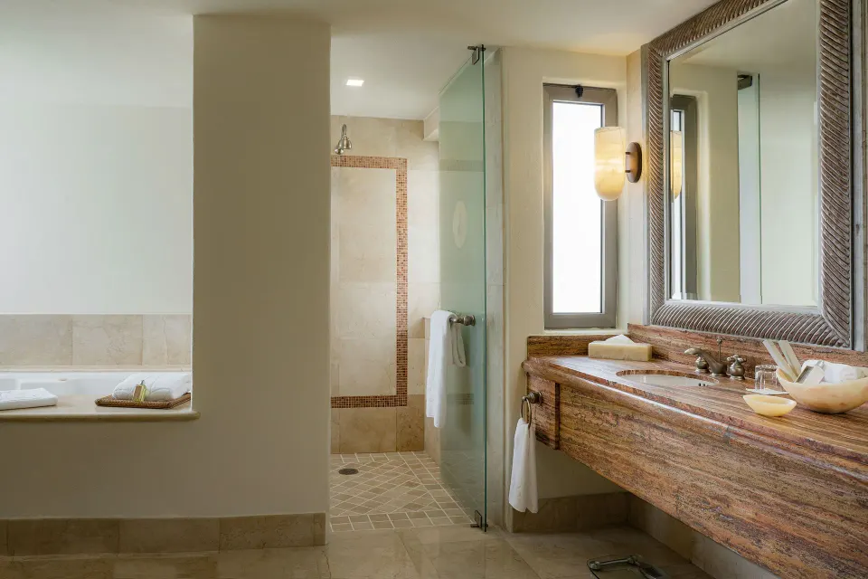 Garden View Casita bathroom with tub, shower, and vanity at Marquis Los Cabos.