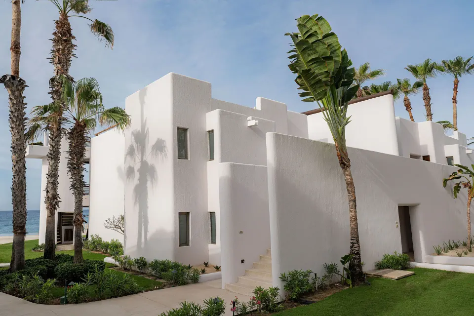 Exterior of Garden View Casitas with palms and white walls at Marquis Los Cabos.