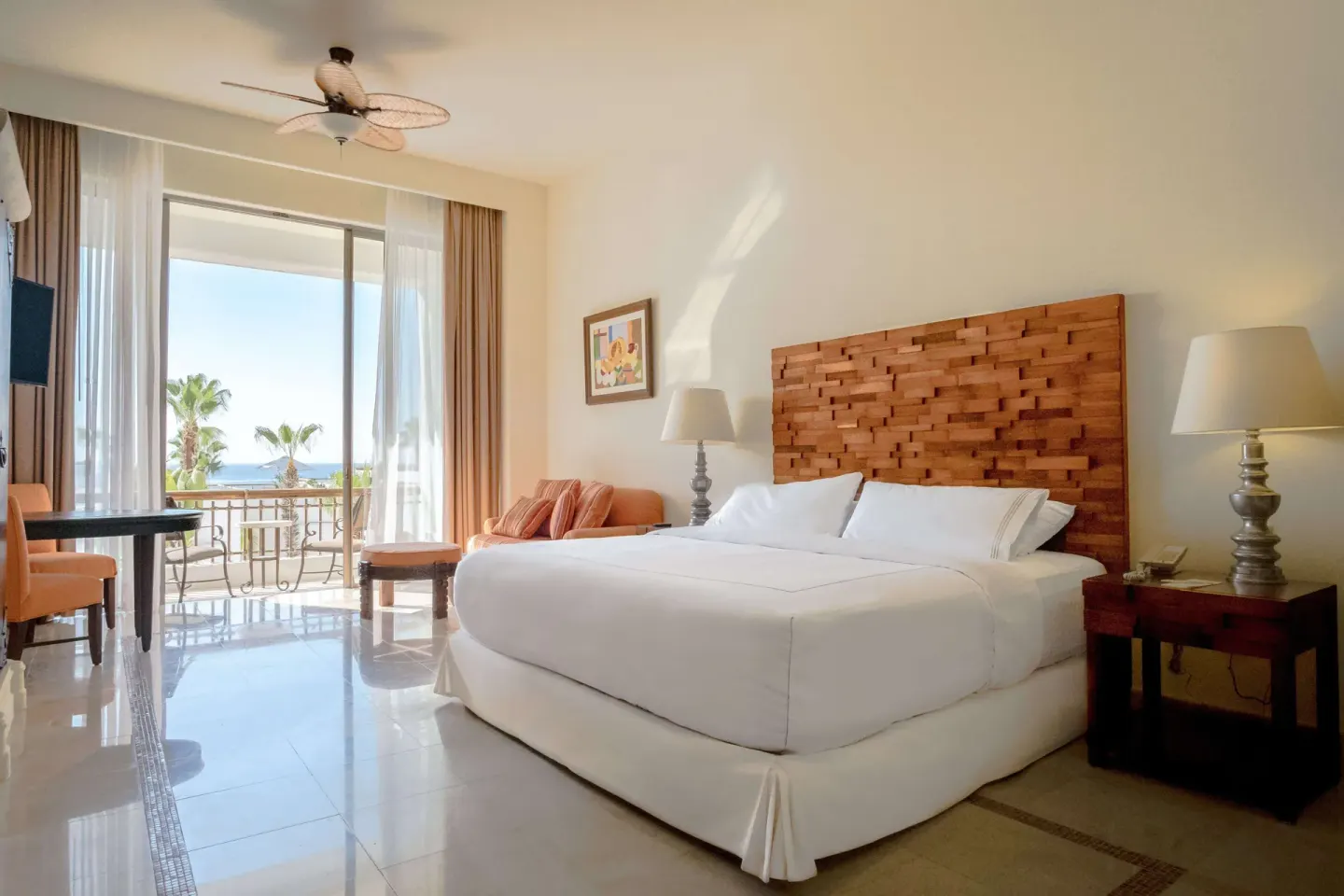 Junior Suite Eden king bed with balcony doors and ocean view at Marquis Los Cabos.