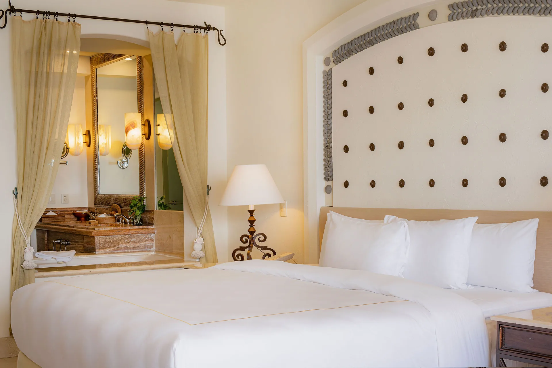 Master Suite king bed and open bathroom vanity at Marquis Los Cabos.