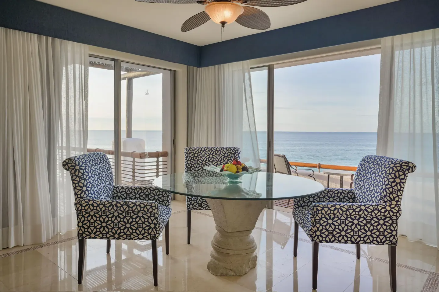 Oceanfront Casita dining area with glass table and sea views at Marquis Los Cabos.