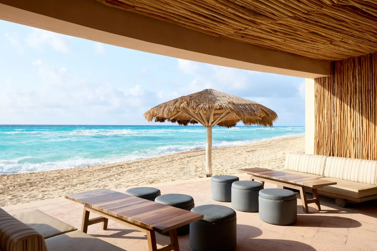 Beachfront lounge seating facing turquoise surf at Marriott Cancun.