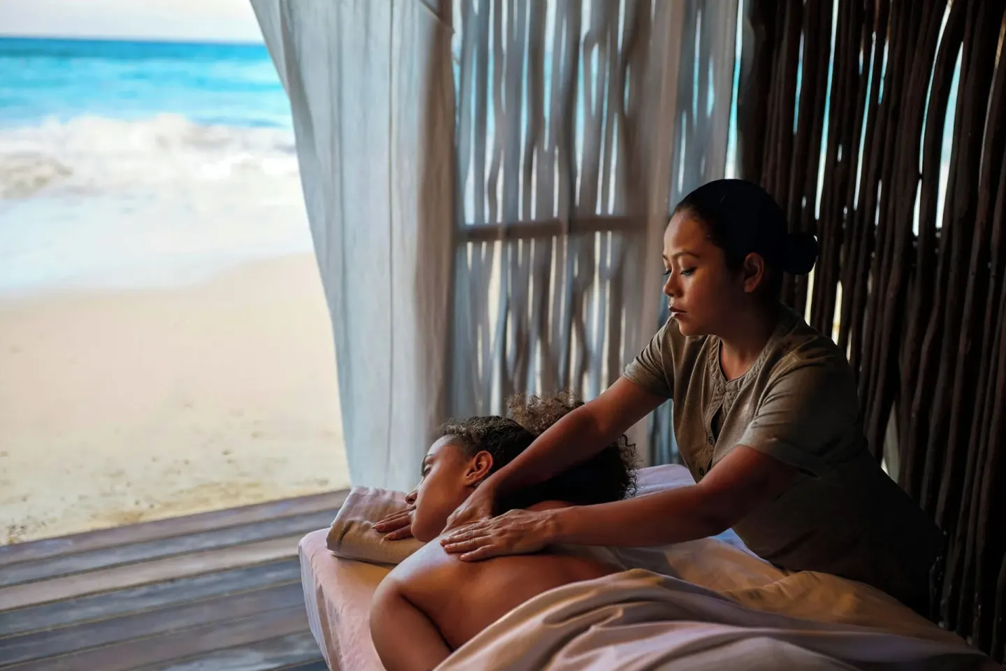 Beachfront massage treatment in a shaded cabana at Marriott Cancun.
