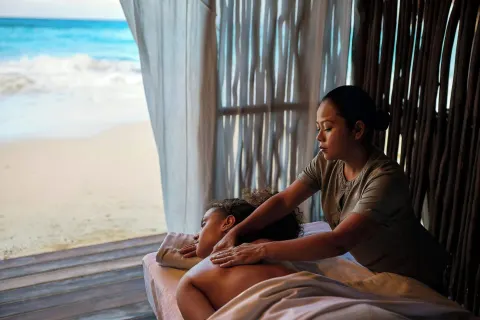 Beachfront massage treatment in a shaded cabana at Marriott Cancun.