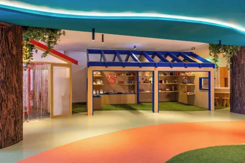Kids' club activity area with display shelves and colorful flooring at Marriott Cancun.