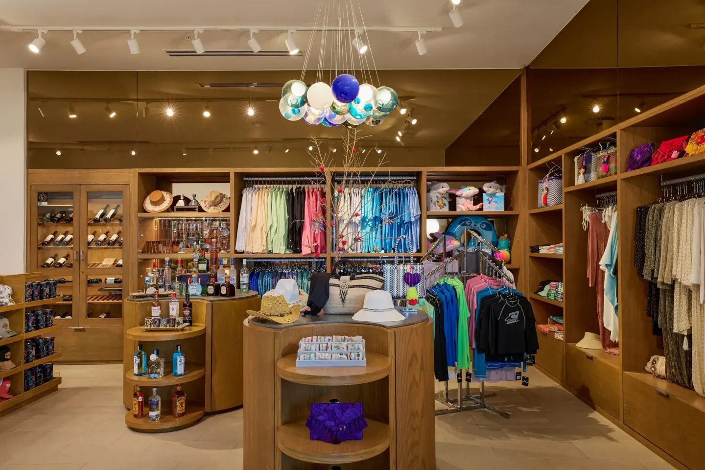 A resort shop displays clothing, hats, bottles, and beach accessories at Marriott Cancun.