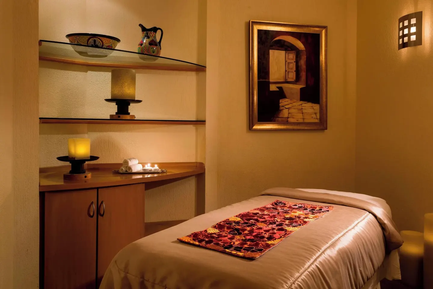 A warm spa treatment room with a massage table at Marriott Cancun.