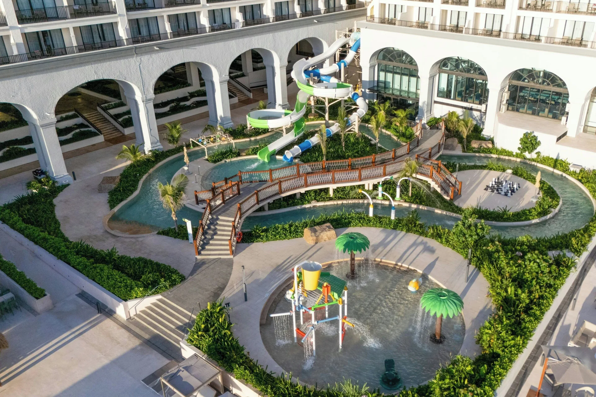 Aerial view of splash pad, waterslide, bridge, and resort arches at Marriott Cancun.