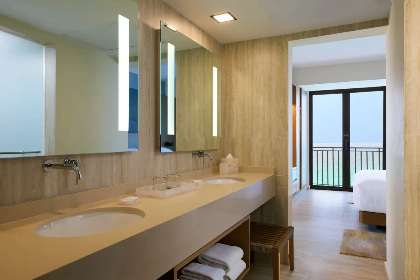 Caribbean Suite bathroom vanity leading to a bedroom and ocean balcony at Marriott Cancun.