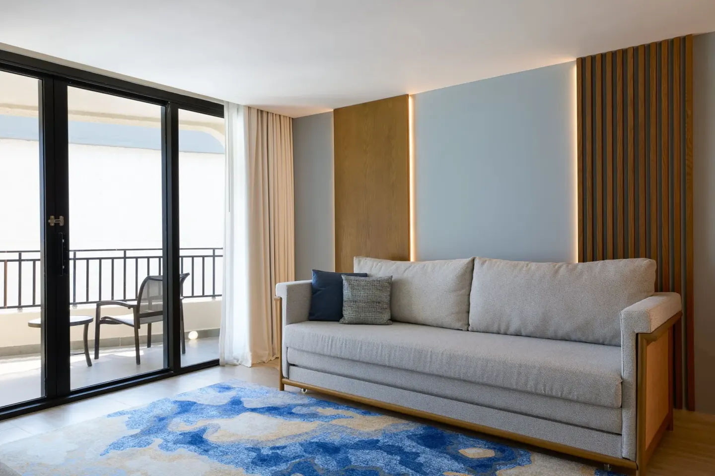Executive Suite living area with sofa and balcony doors at Marriott Cancun.