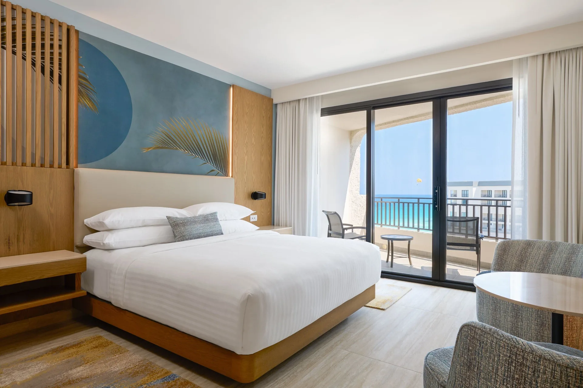 Junior Suite king bed and balcony with ocean view at Marriott Cancun.