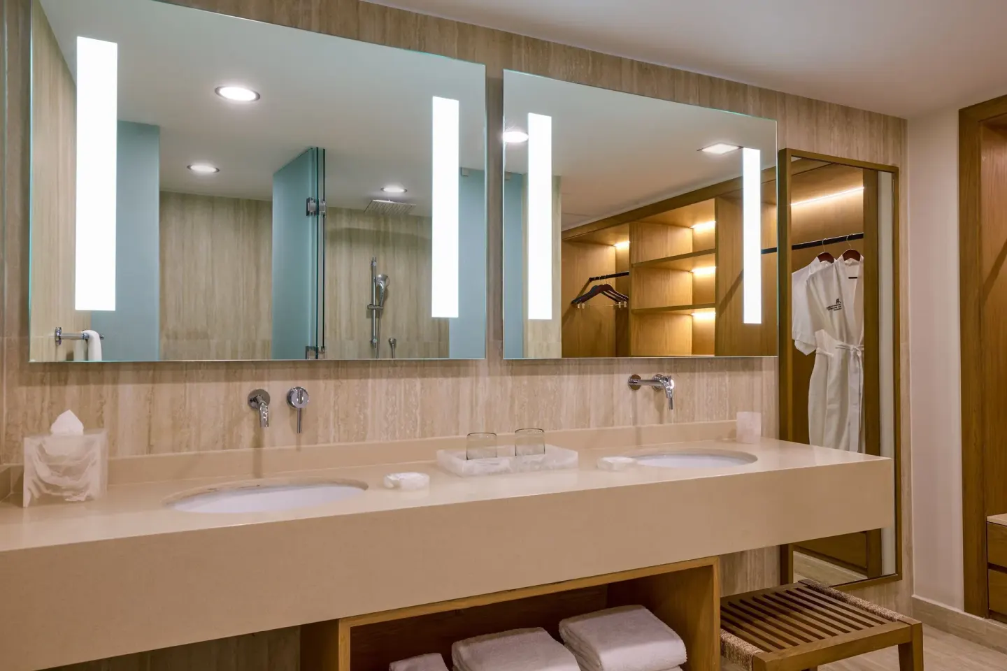 Magna Suite bathroom with double vanity, mirrors, shower, and open closet at Marriott Cancun.