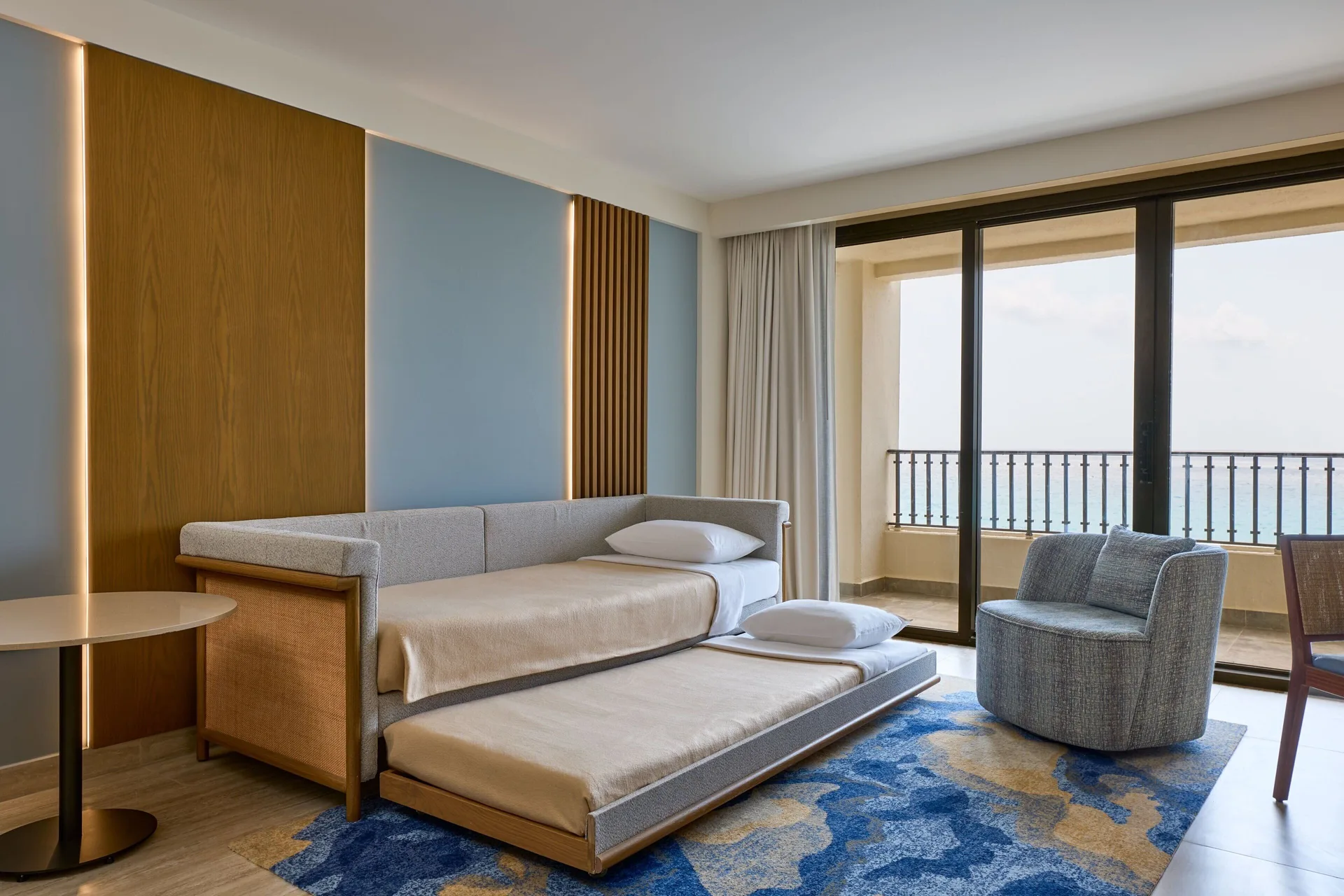 Magna Suite living area with daybed, balcony, and ocean view at Marriott Cancun.