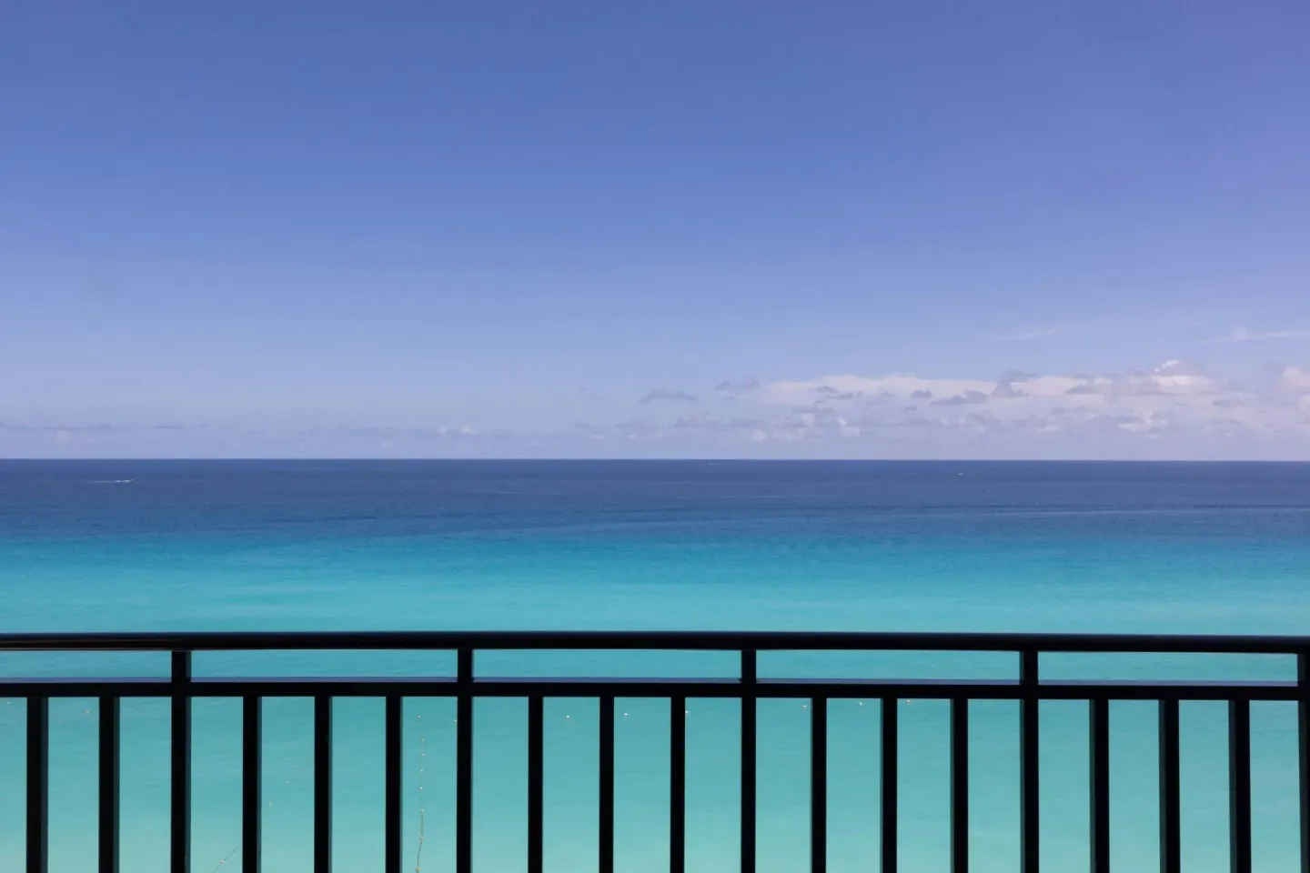 Ocean front balcony view of turquoise water and sky at Marriott Cancun.
