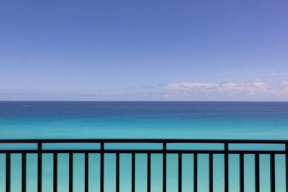 Ocean front balcony view of turquoise water and sky at Marriott Cancun.