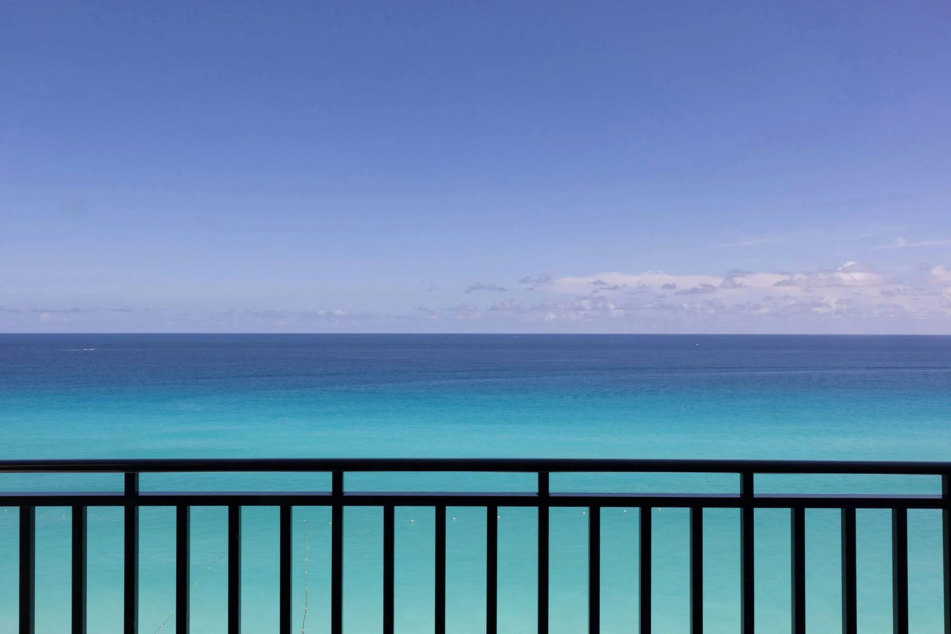 Ocean front balcony view of turquoise water and sky at Marriott Cancun.