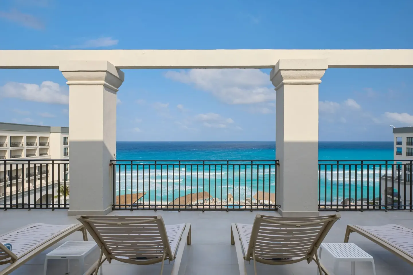 Presidential Suite balcony with lounge chairs and ocean view at Marriott Cancun.