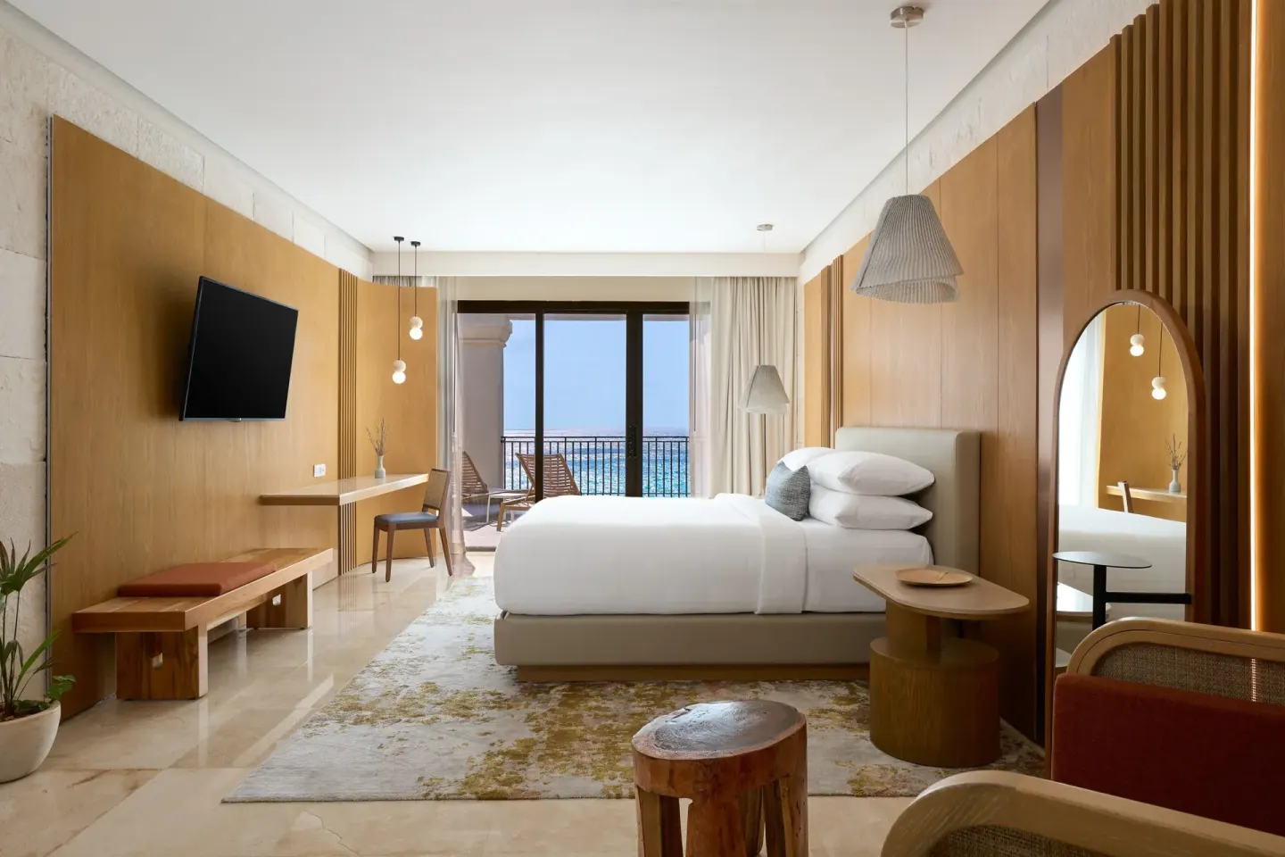 Presidential Suite bedroom with king bed, desk, balcony, and ocean view at Marriott Cancun.