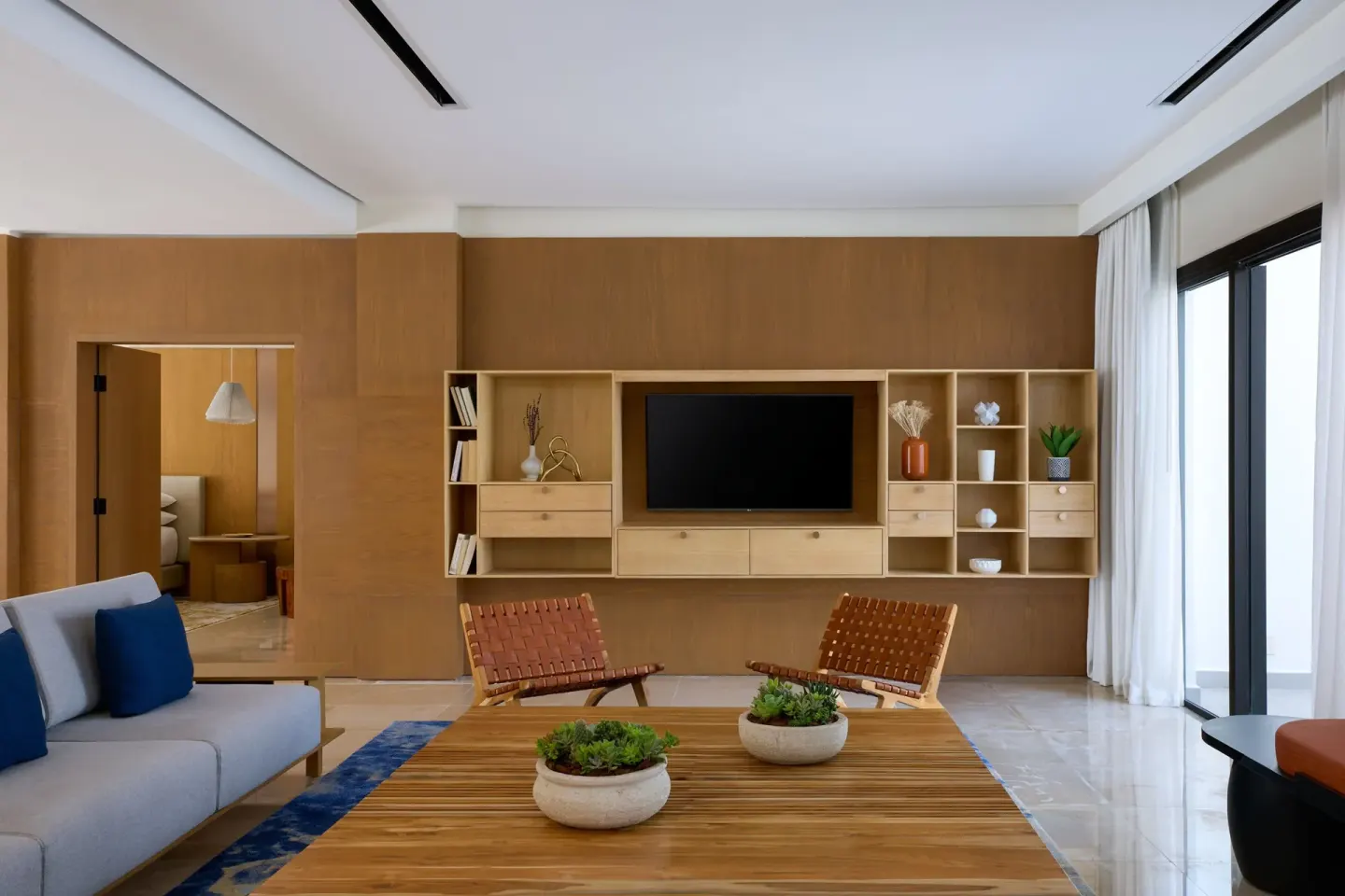 Presidential Suite living room with TV shelving and coffee table at Marriott Cancun.