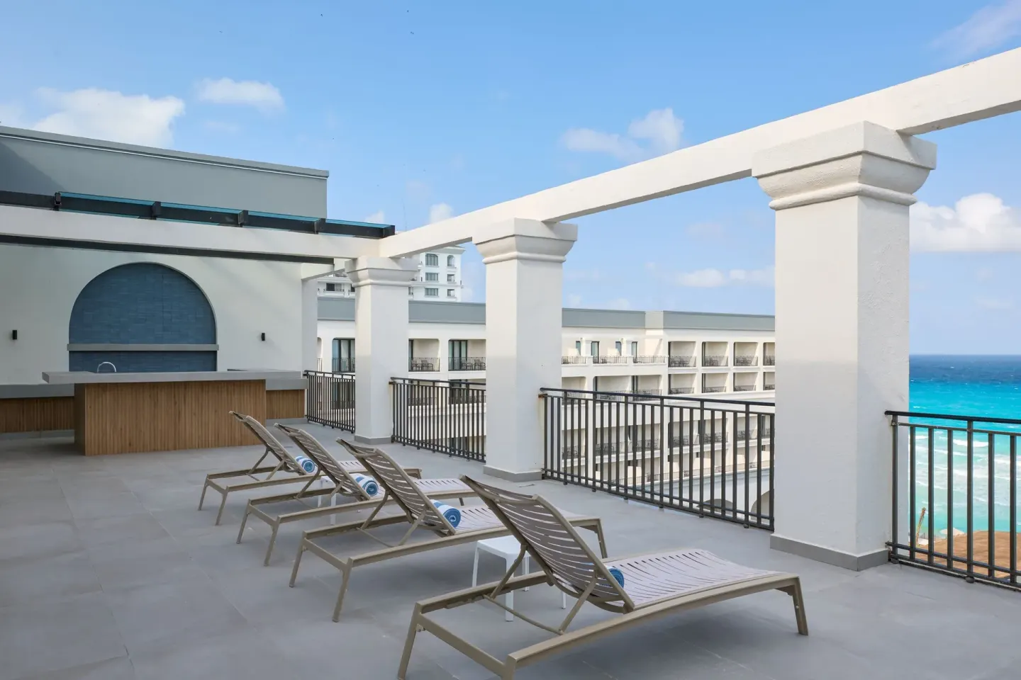 Presidential Suite terrace with lounge chairs and ocean view at Marriott Cancun.