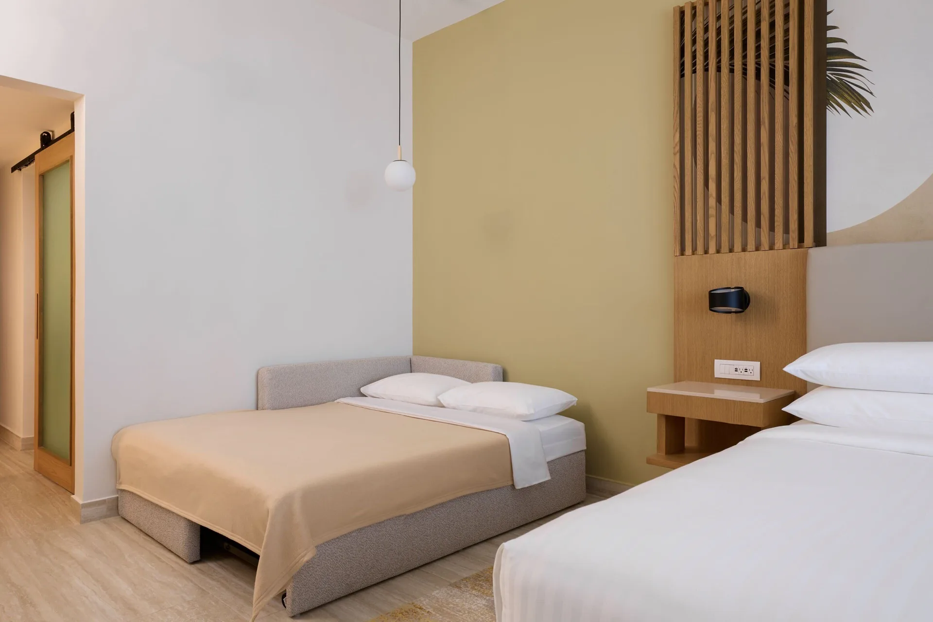 Guest room with king bed and sofa bed at Marriott Cancun.