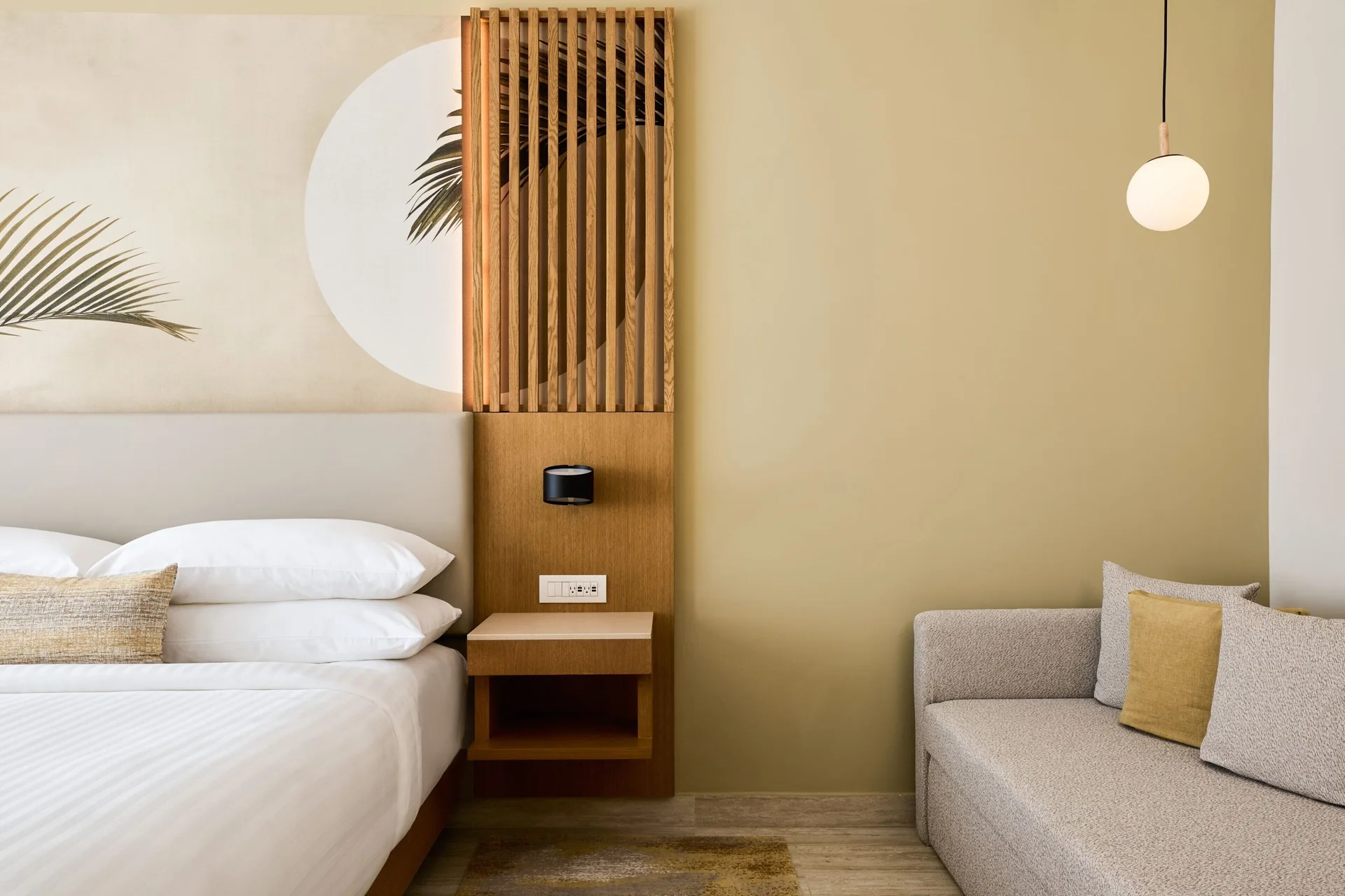 King bed and sofa seating in a resort view guest room at Marriott Cancun.