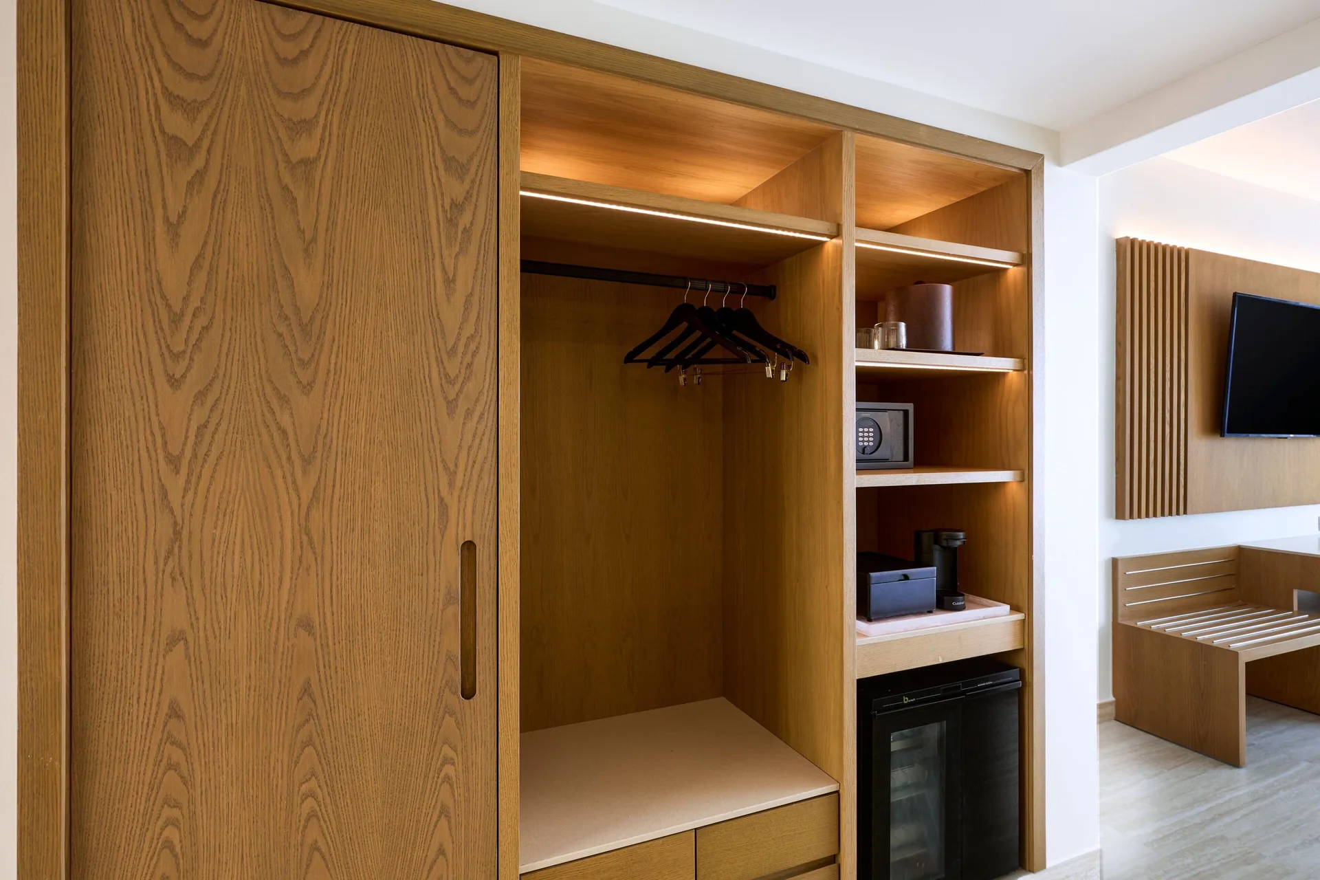 Open wood wardrobe and room storage in a guest room at Marriott Cancun.