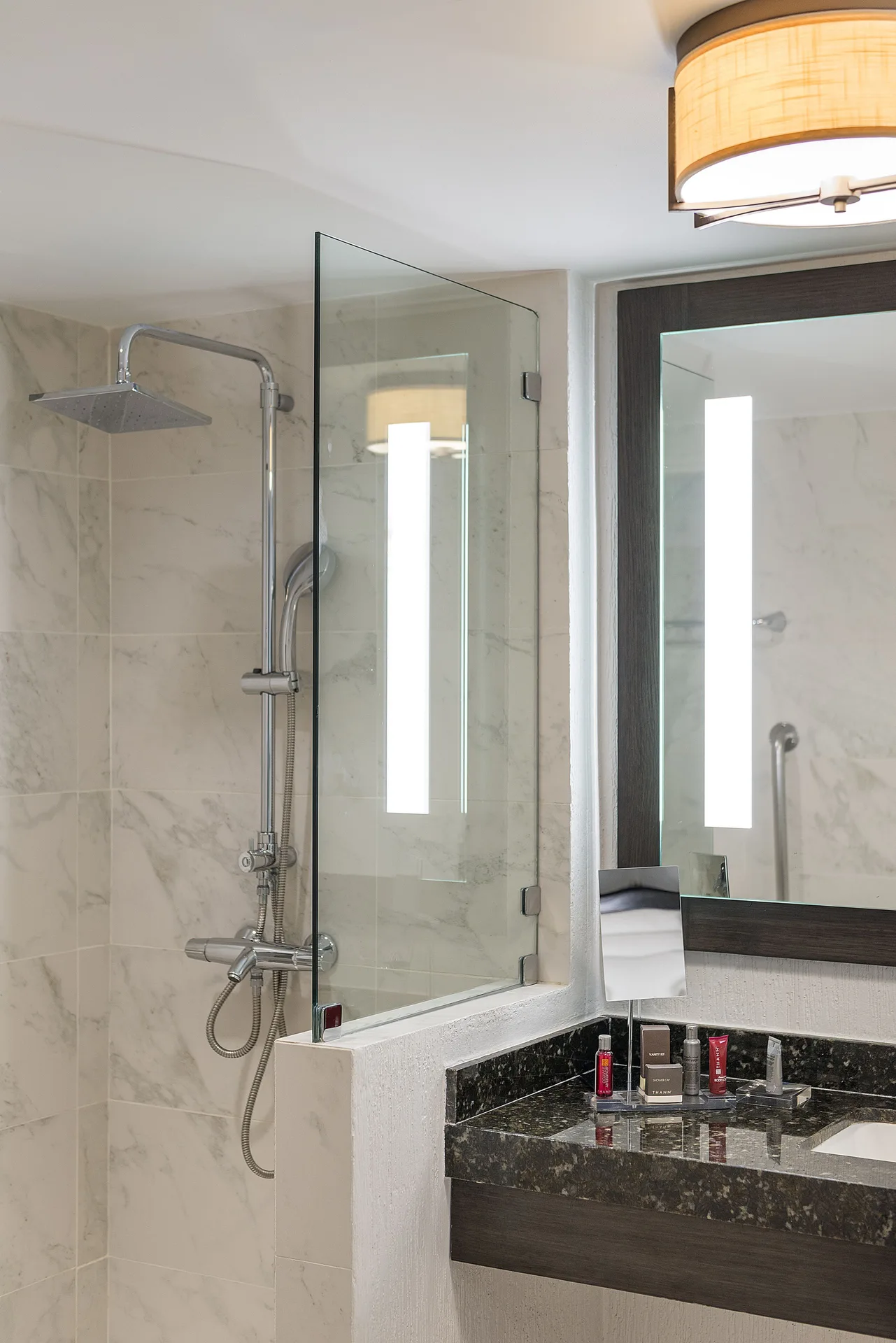 Guest bathroom with glass shower and vanity in a room at Marriott Cancun.