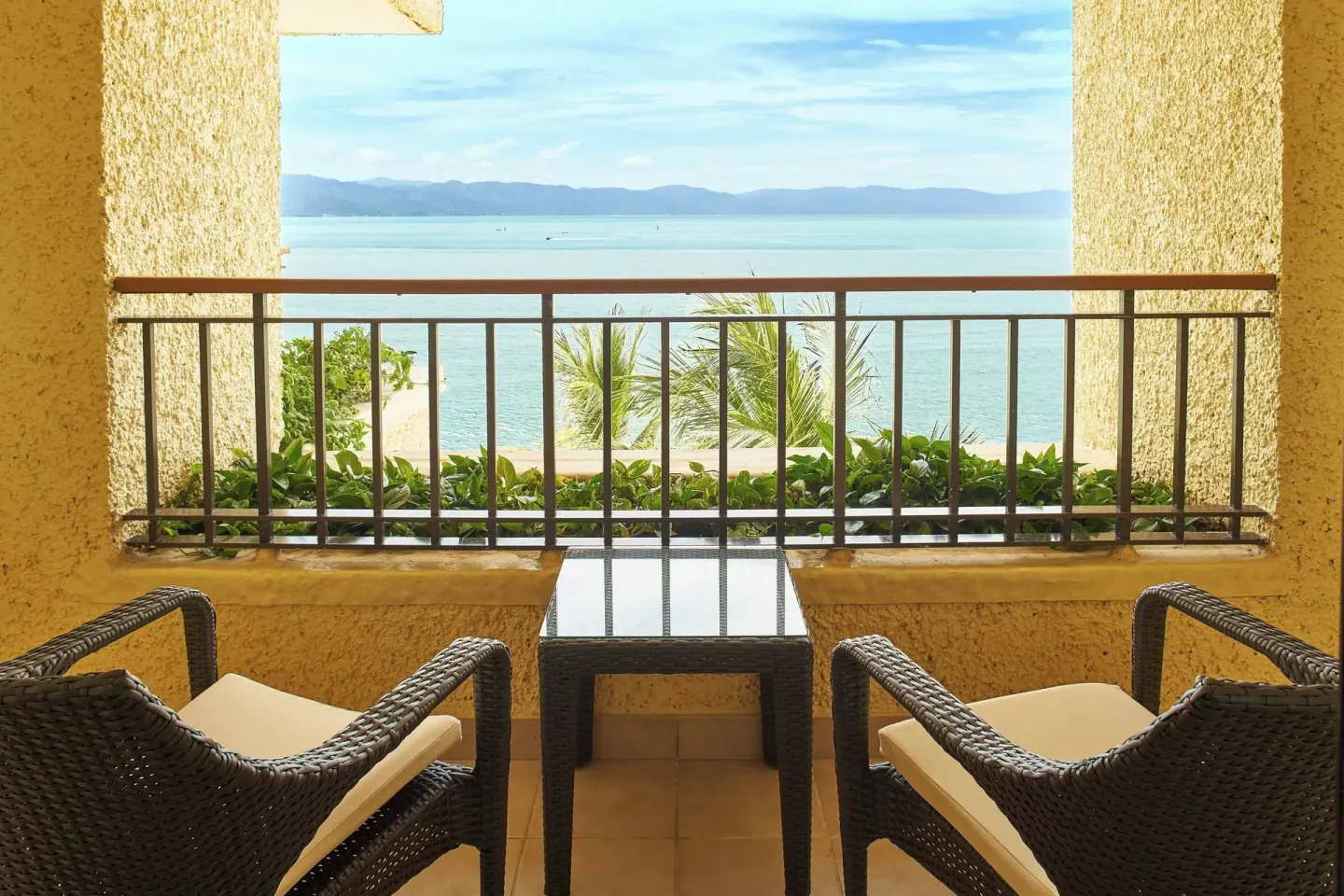 Covered balcony with two chairs and bay view at Marriott Puerto Vallarta Resort & Spa.