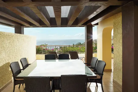 Covered terrace dining table with ocean view at Marriott Puerto Vallarta Resort & Spa.