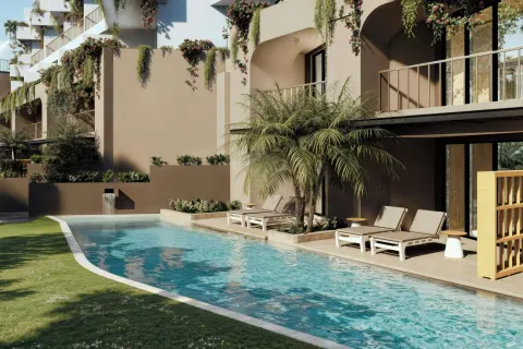 Curved pool with loungers, palms, and balcony terraces at Marriott Puerto Vallarta Resort & Spa.