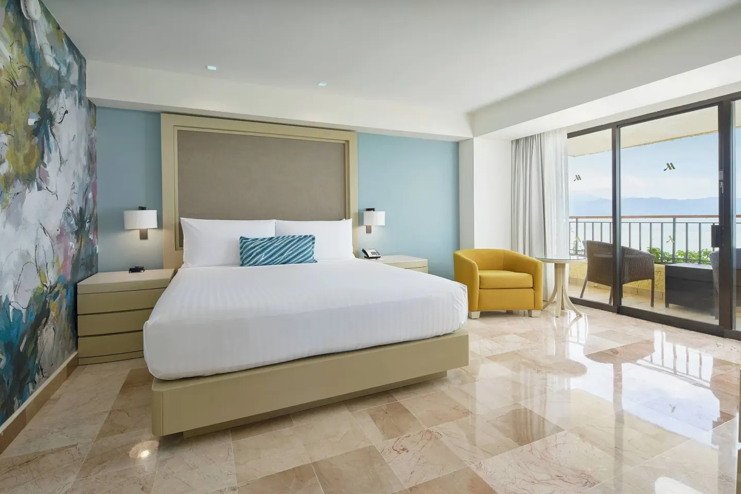 King bed guest room with balcony and ocean view at Marriott Puerto Vallarta Resort & Spa.