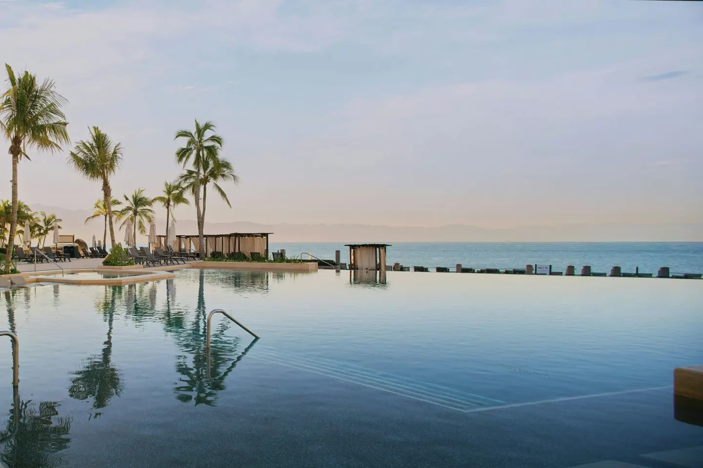 Infinity pool edge and palm-lined deck at Marriott Puerto Vallarta Resort & Spa.