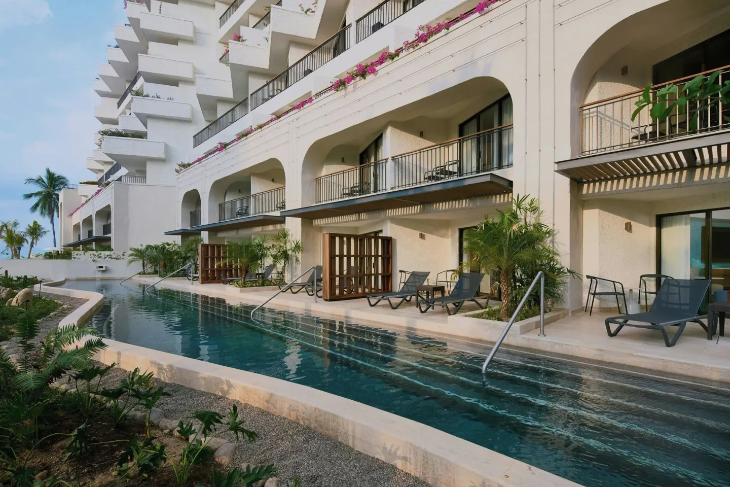 Long pool beside balconies and lounge chairs at Marriott Puerto Vallarta Resort & Spa.