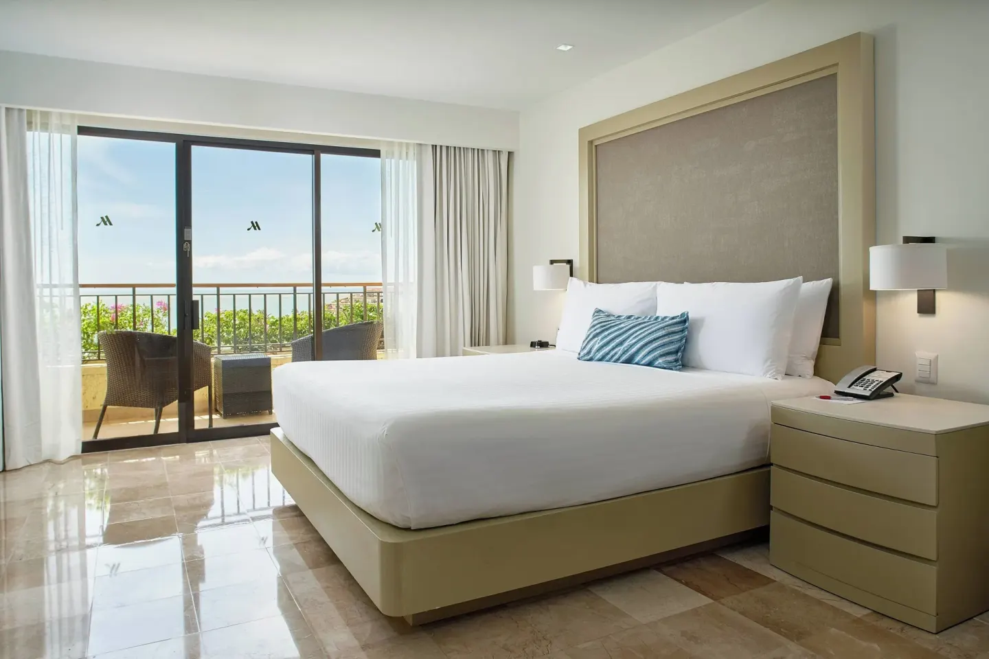 King guest room with balcony and ocean view at Marriott Puerto Vallarta Resort & Spa.