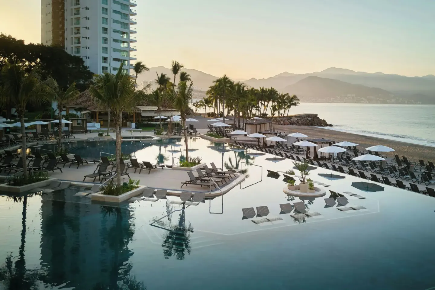 Oceanfront pool deck at sunset at Marriott Puerto Vallarta Resort & Spa.