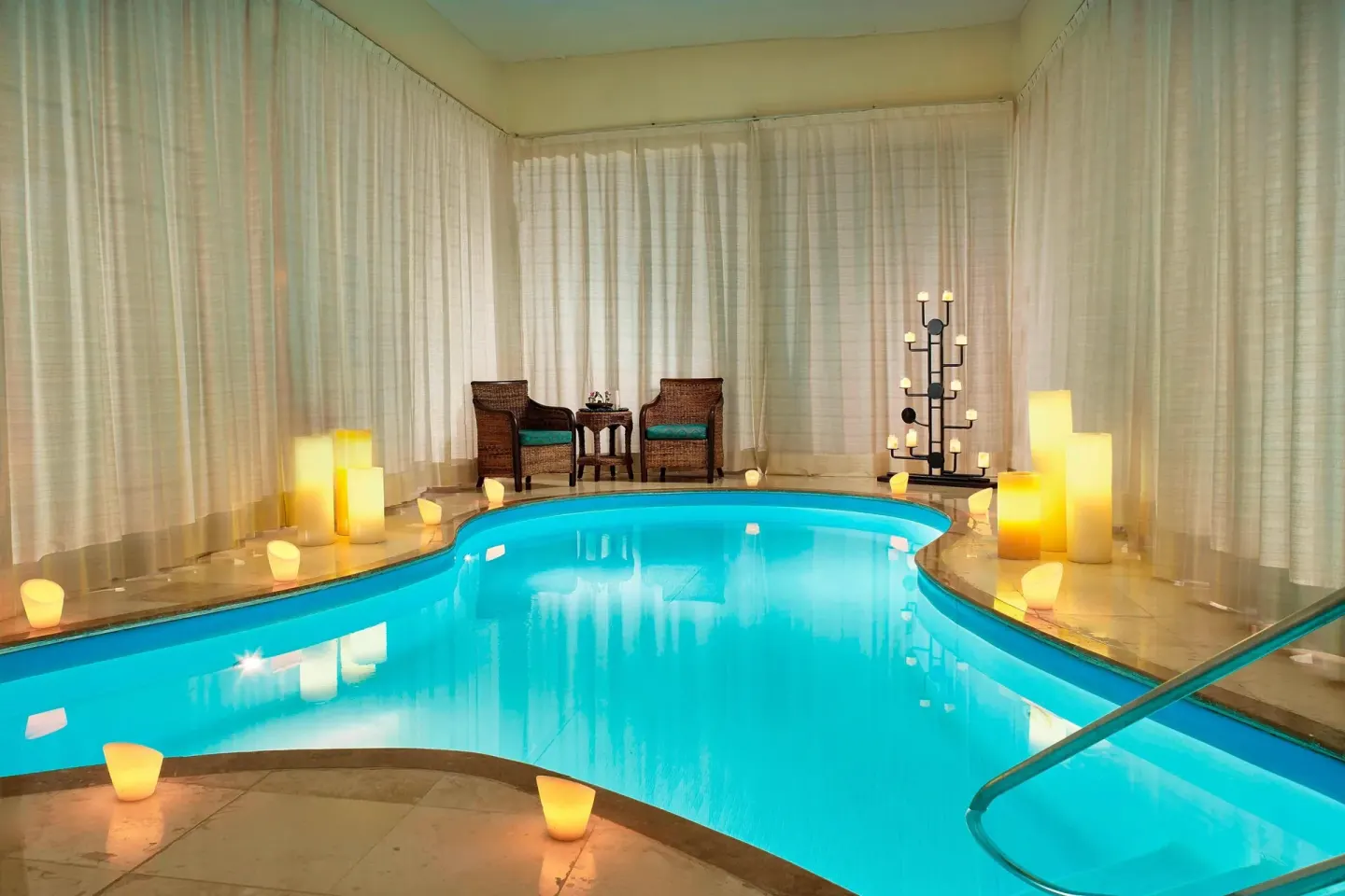 Spa pool with candles, curtains, and seating at Marriott Puerto Vallarta Resort & Spa.