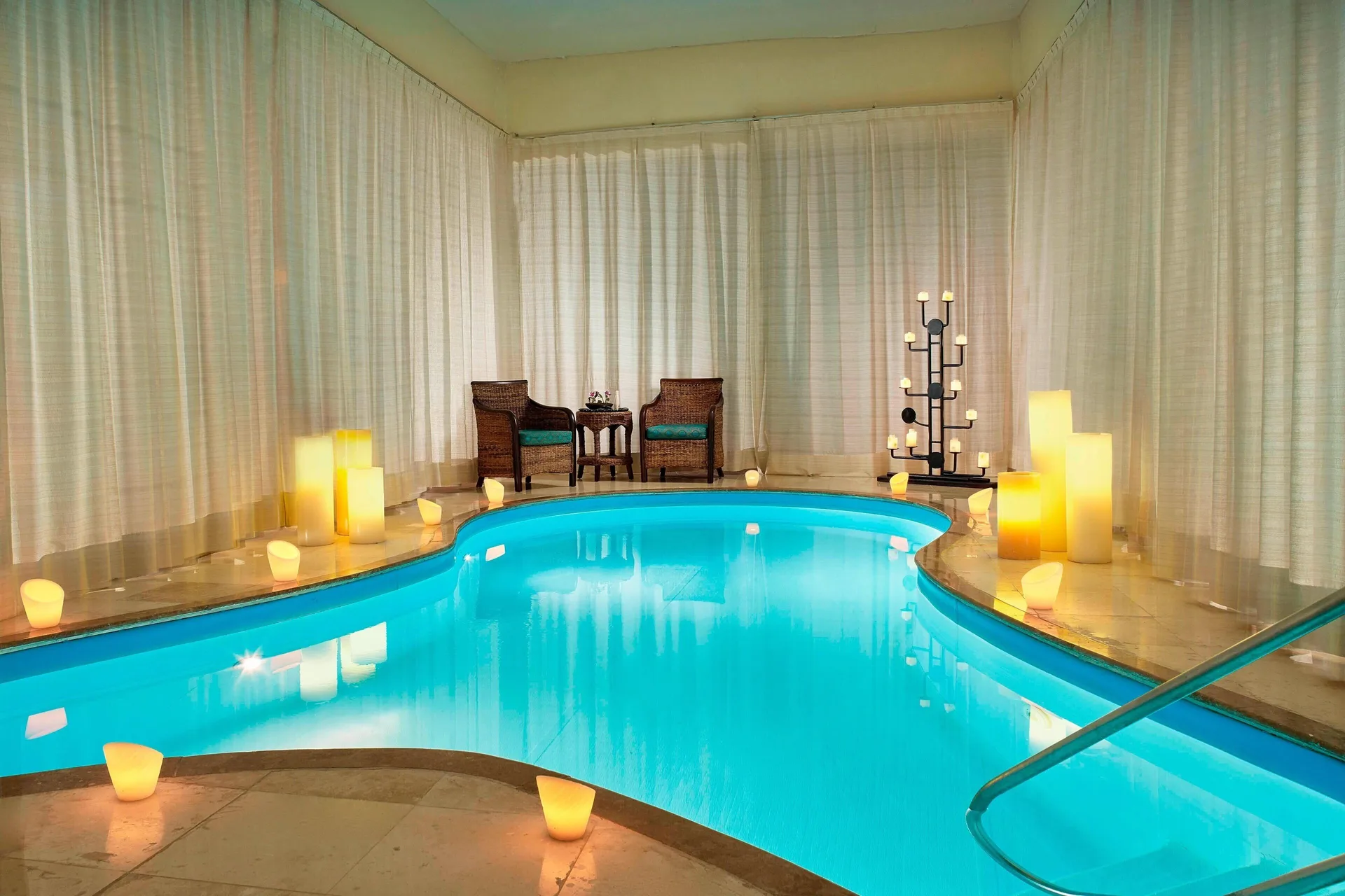Spa pool with candles, curtains, and seating at Marriott Puerto Vallarta Resort & Spa.