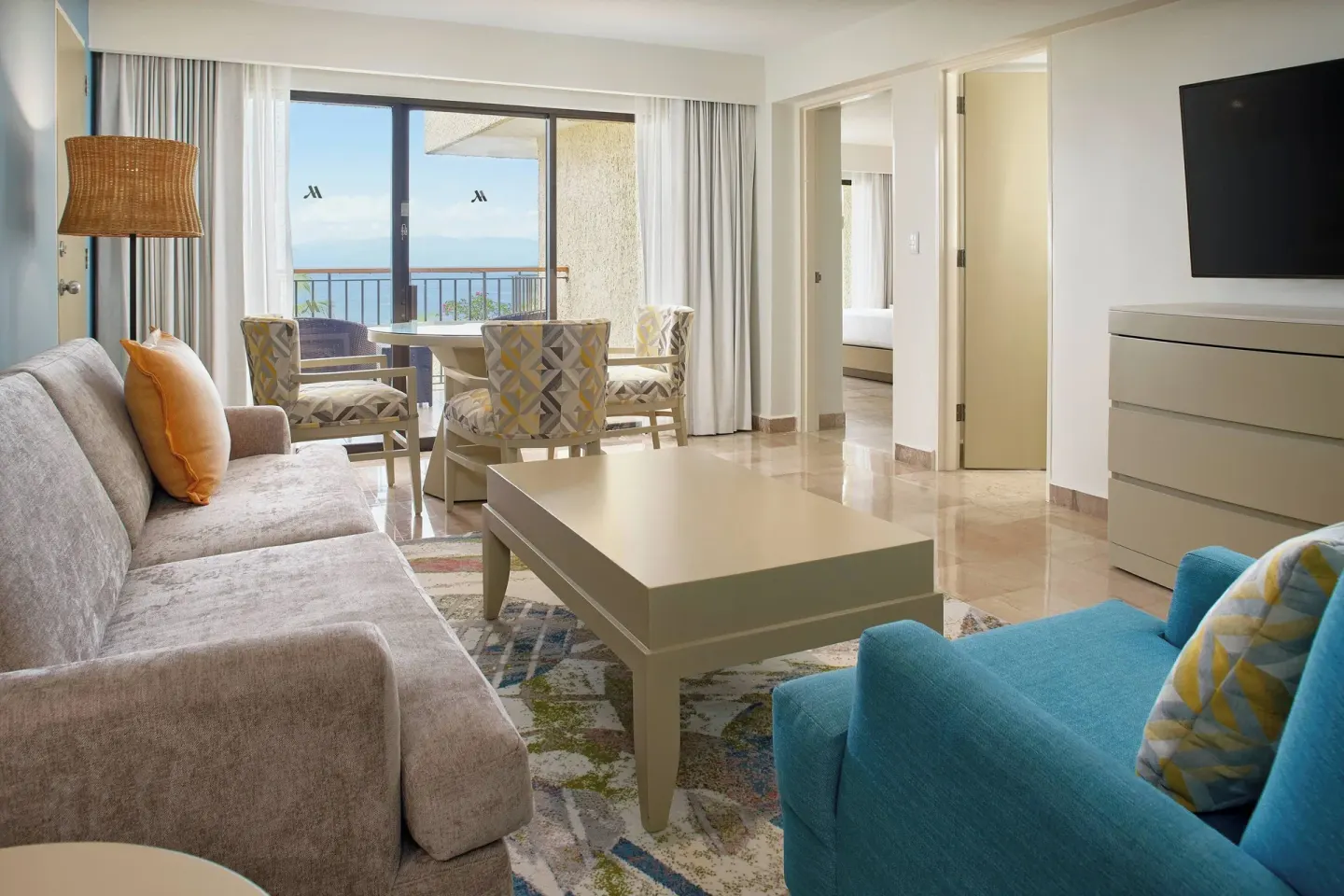 Junior Suite ocean-view living room at Marriott Puerto Vallarta Resort & Spa with balcony and seating.