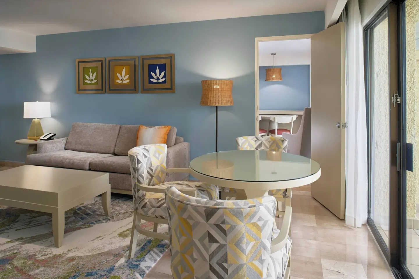 Junior Suite ocean-view sitting area at Marriott Puerto Vallarta Resort & Spa with sofa and round dining table.