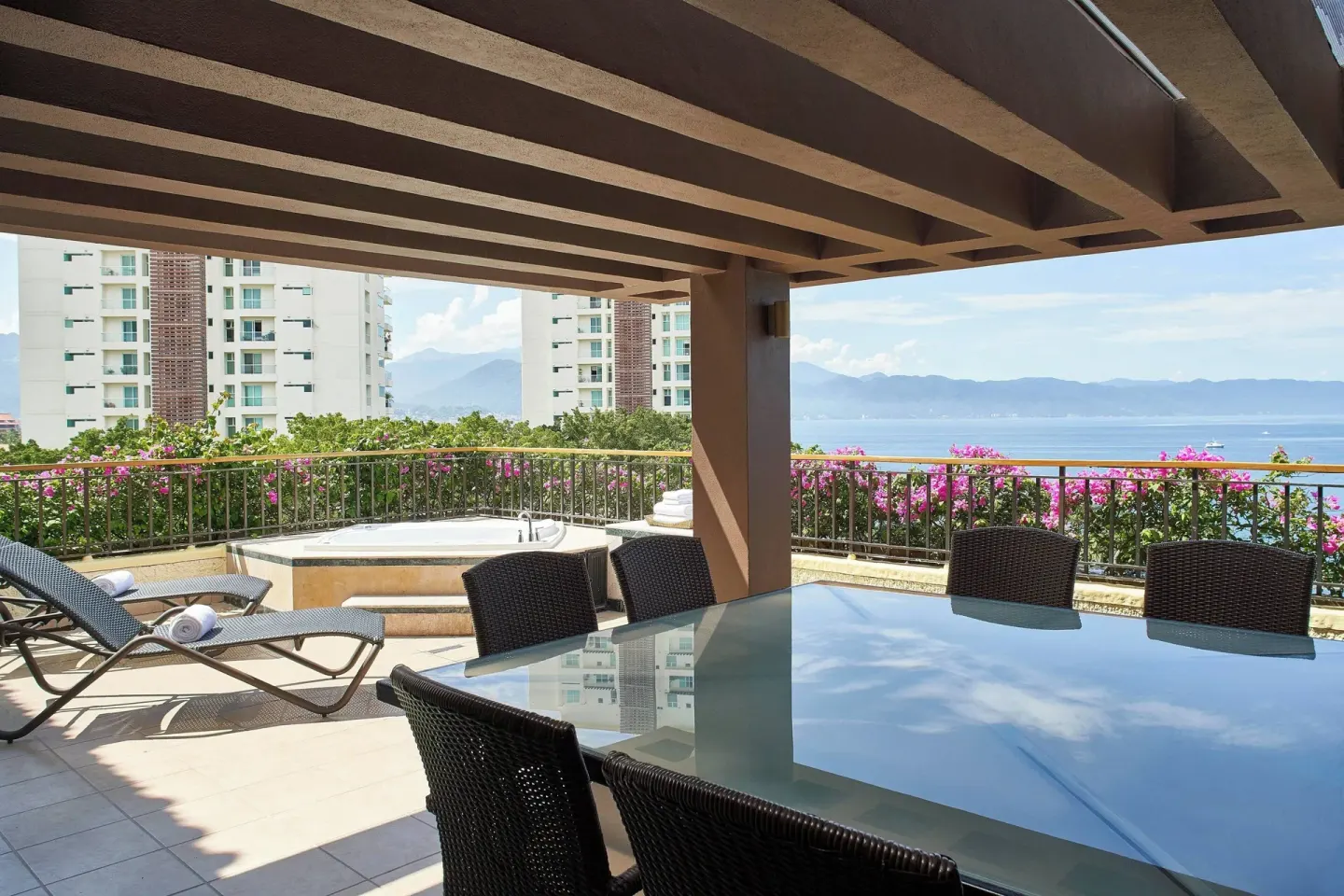 Covered Luxury Suite terrace with dining table and hot tub at Marriott Puerto Vallarta Resort & Spa.