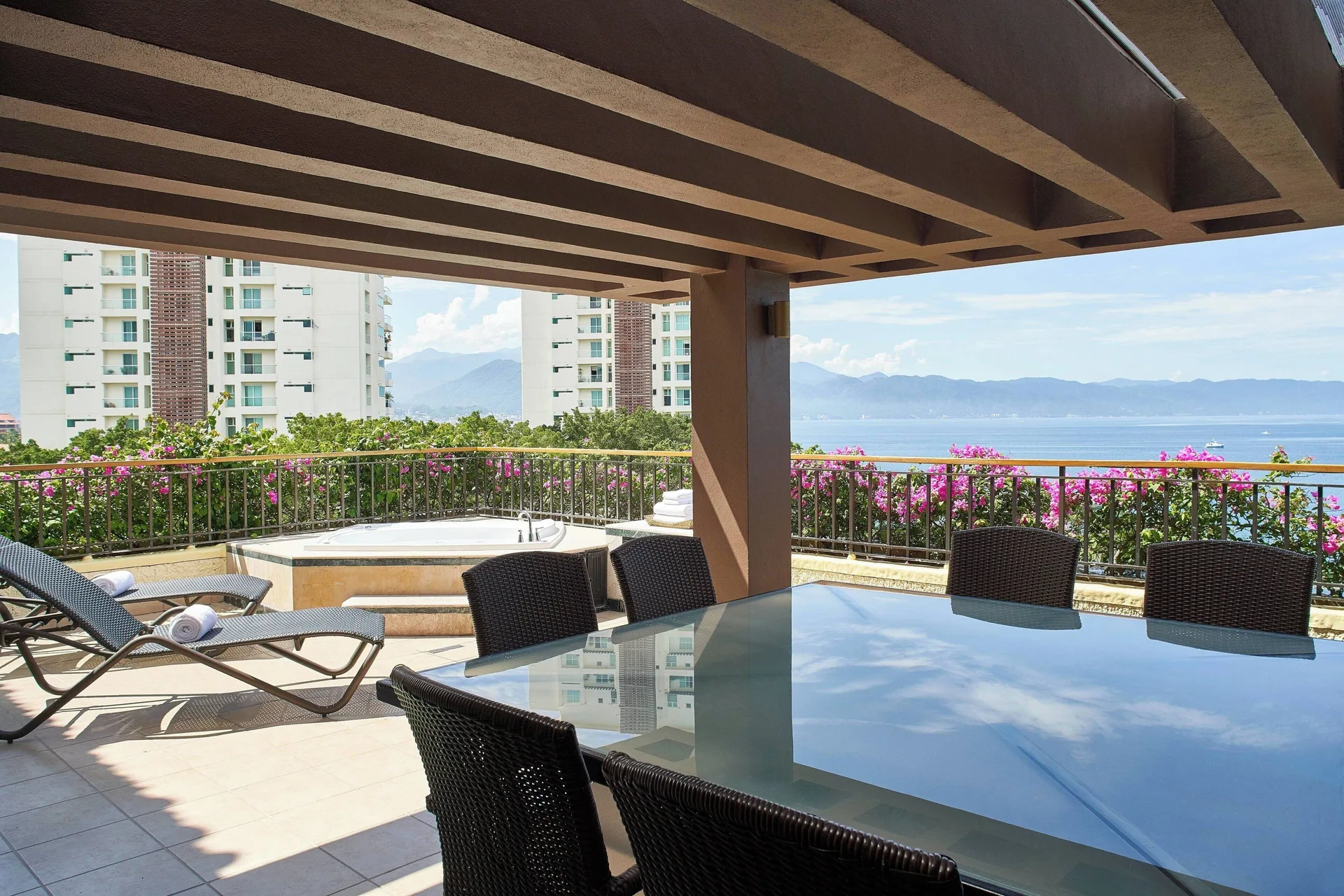 Covered Luxury Suite terrace with dining table and hot tub at Marriott Puerto Vallarta Resort & Spa.