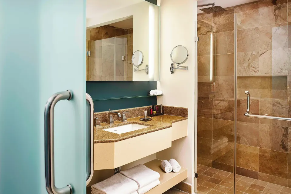 Panoramic Ocean View room bathroom at Marriott Puerto Vallarta Resort & Spa with vanity and shower.