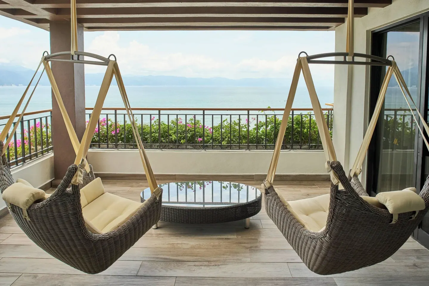 Oceanfront terrace with hanging chairs at Marriott Puerto Vallarta Resort & Spa.