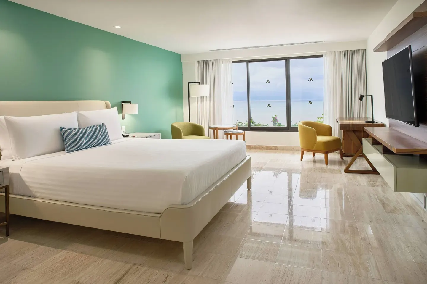 Presidential Suite king bedroom with ocean-facing windows at Marriott Puerto Vallarta Resort & Spa.