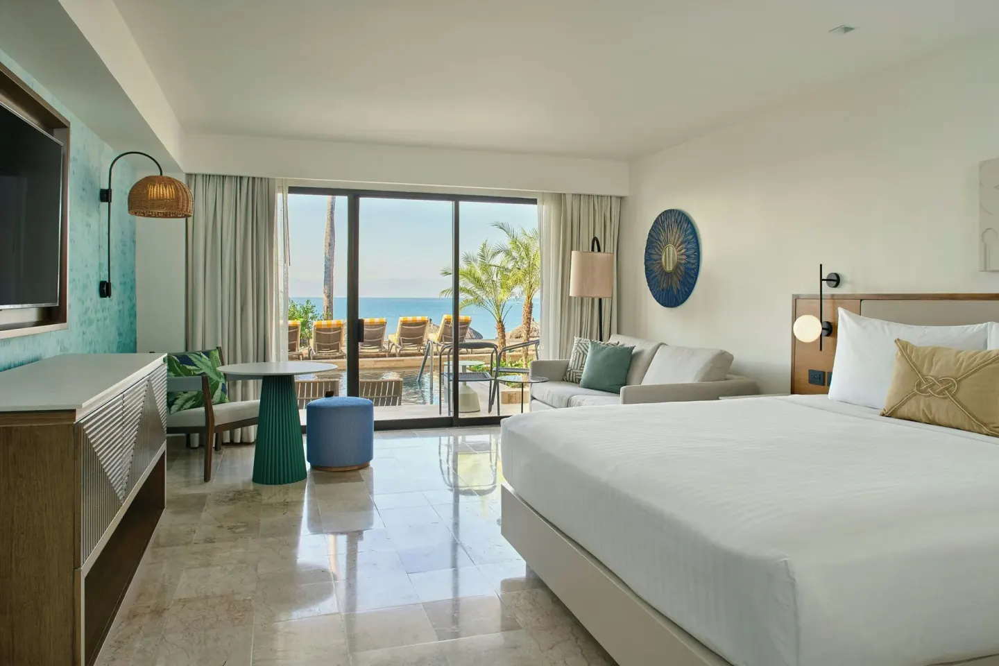 Oceanfront king room with sofa and terrace view at Marriott Puerto Vallarta Resort & Spa.