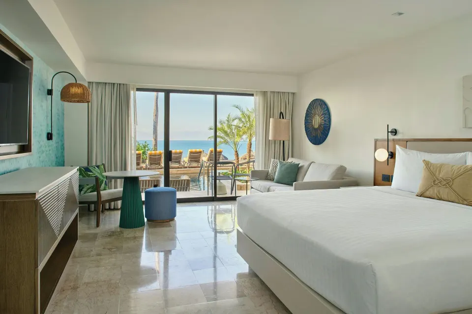 Oceanfront king room with sofa and terrace view at Marriott Puerto Vallarta Resort & Spa.