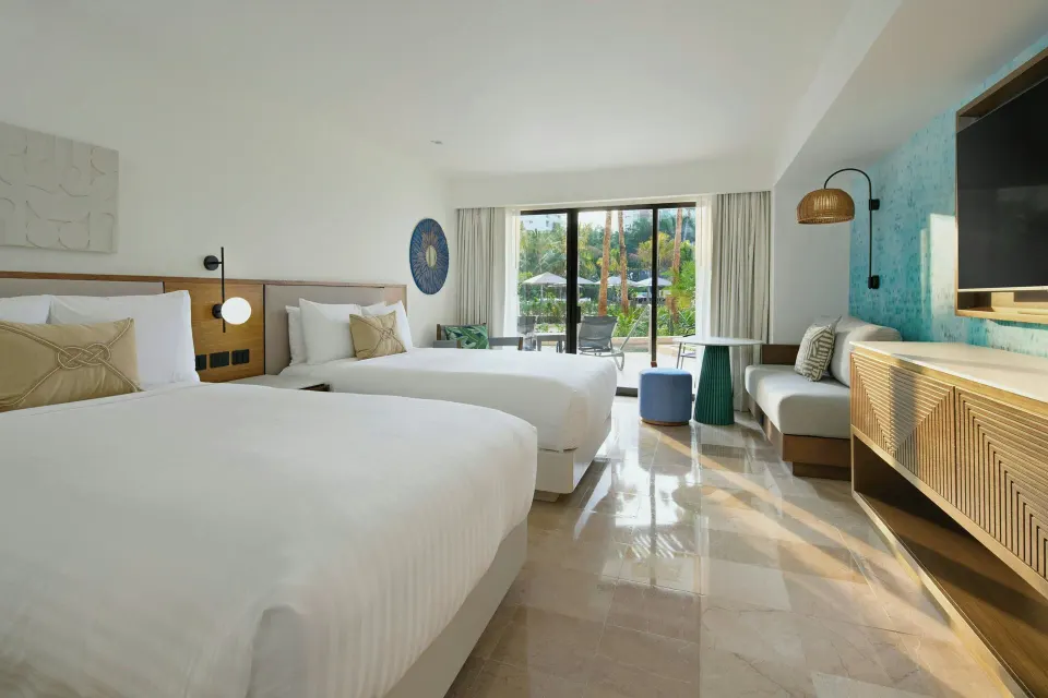 Pool View room with two beds and balcony at Marriott Puerto Vallarta Resort & Spa.